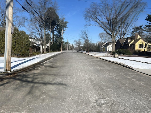 view of road with curbs, a residential view, and sidewalks