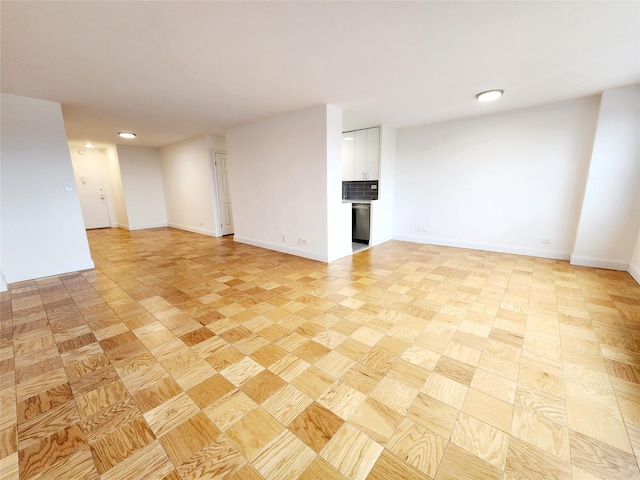 unfurnished room with light parquet floors