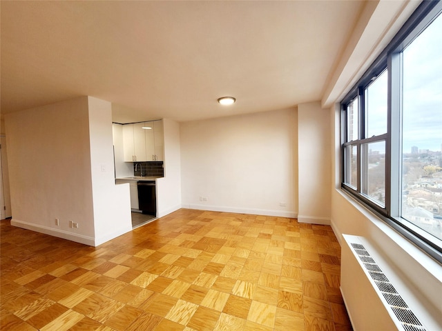 unfurnished living room with light parquet flooring