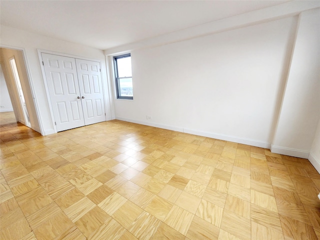 unfurnished bedroom featuring light parquet flooring