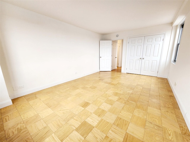 unfurnished bedroom with a closet and light parquet floors