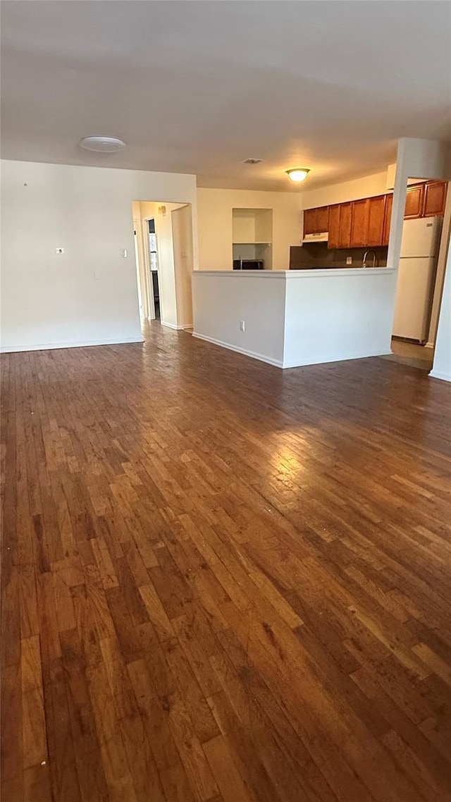 unfurnished living room featuring dark hardwood / wood-style flooring