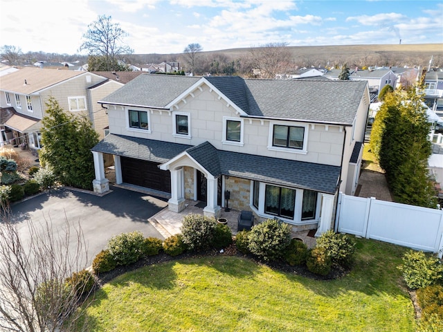 view of front of house featuring a front yard and a garage