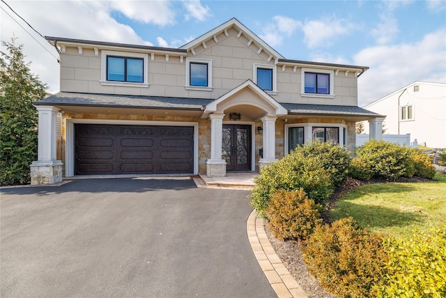 view of front of house featuring a front yard and a garage