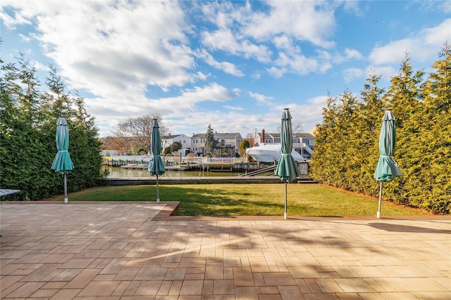 view of property's community with a patio and a lawn