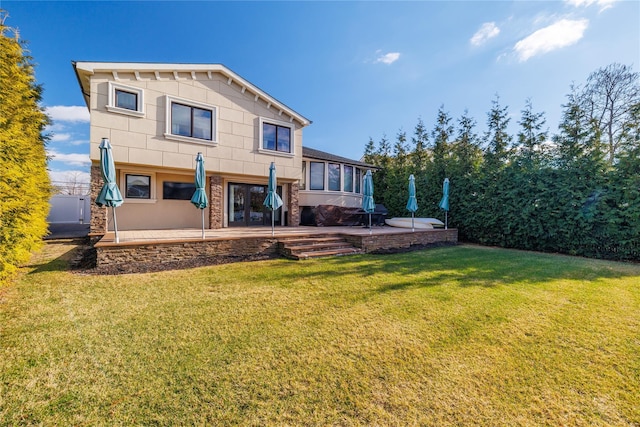 rear view of property featuring a patio and a lawn