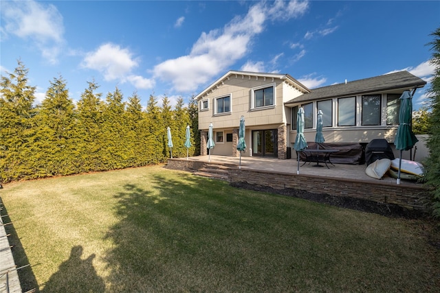 rear view of property featuring a yard and a patio