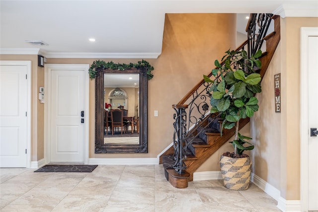 entryway featuring crown molding