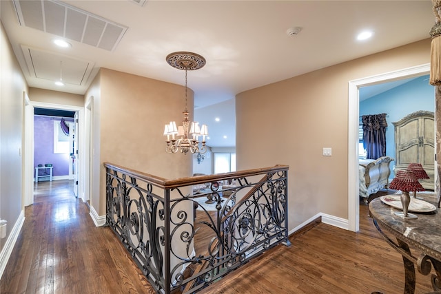 hallway with dark hardwood / wood-style flooring and a chandelier