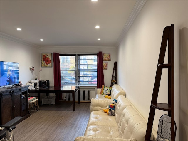 living room featuring radiator, ornamental molding, and hardwood / wood-style flooring