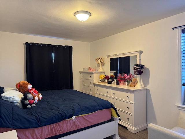 bedroom featuring dark hardwood / wood-style flooring