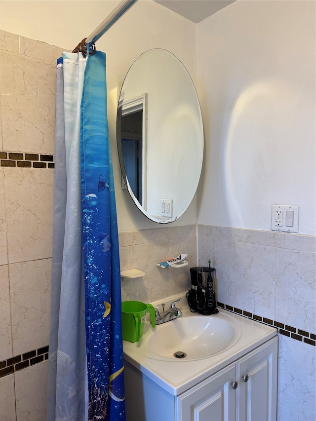 bathroom with vanity and tile walls