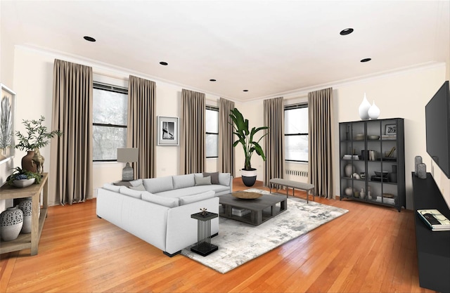 living room featuring a healthy amount of sunlight, ornamental molding, and light hardwood / wood-style floors