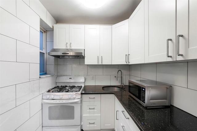 kitchen with white cabinetry, gas range gas stove, sink, backsplash, and dark stone counters