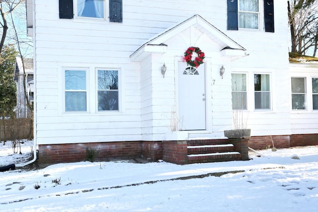 view of snow covered property entrance