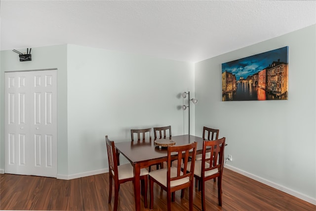 dining area featuring dark wood-type flooring