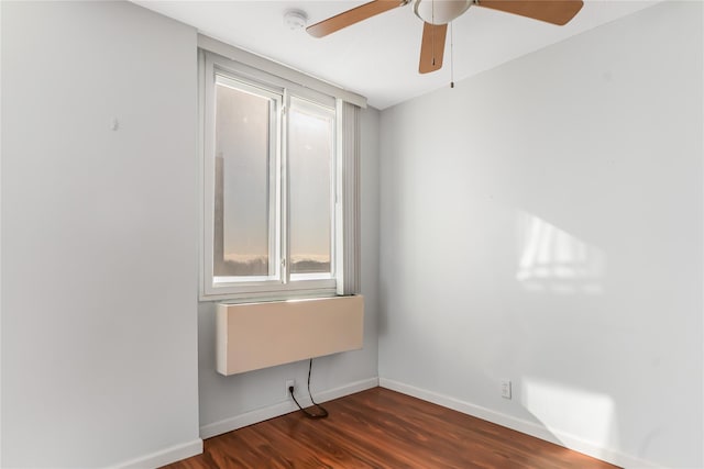 spare room featuring ceiling fan and dark wood-type flooring