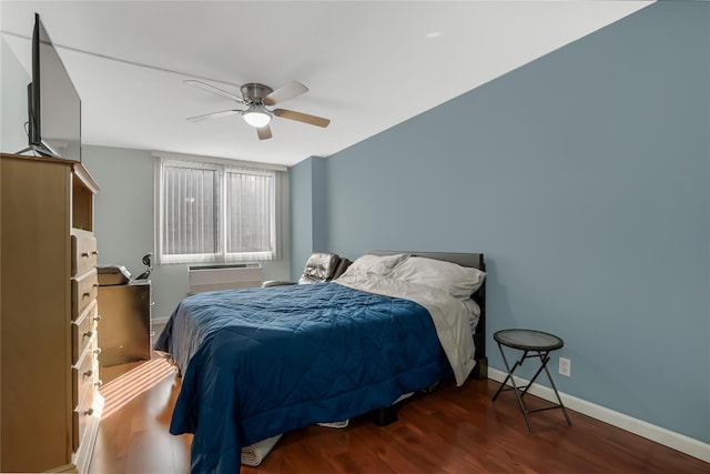 bedroom featuring a wall unit AC, ceiling fan, and dark wood-type flooring