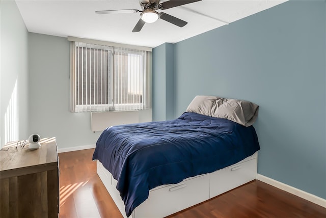 bedroom featuring dark hardwood / wood-style flooring and ceiling fan