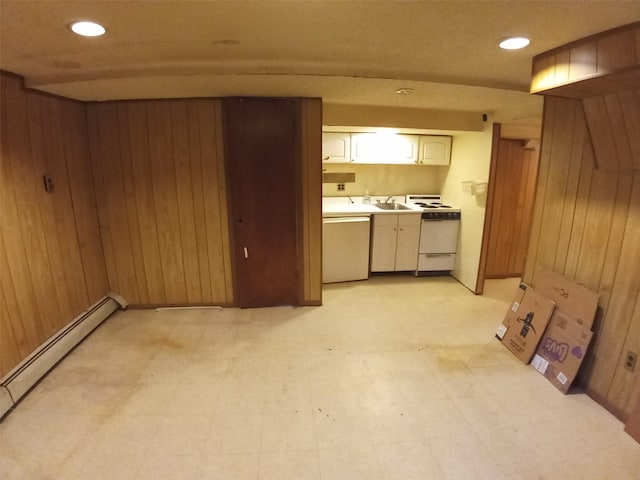 kitchen with wooden walls, dishwashing machine, and white stove