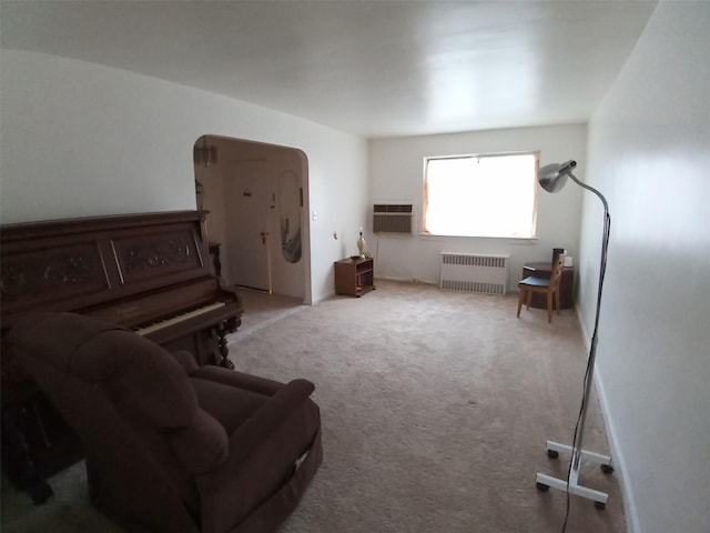 living room featuring a wall mounted AC, carpet flooring, and radiator