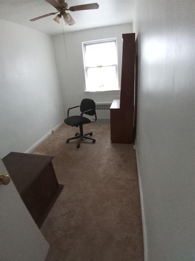 office space with carpet flooring, radiator heating unit, and ceiling fan