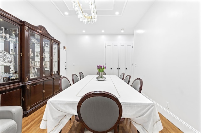 dining area featuring an inviting chandelier and light hardwood / wood-style flooring