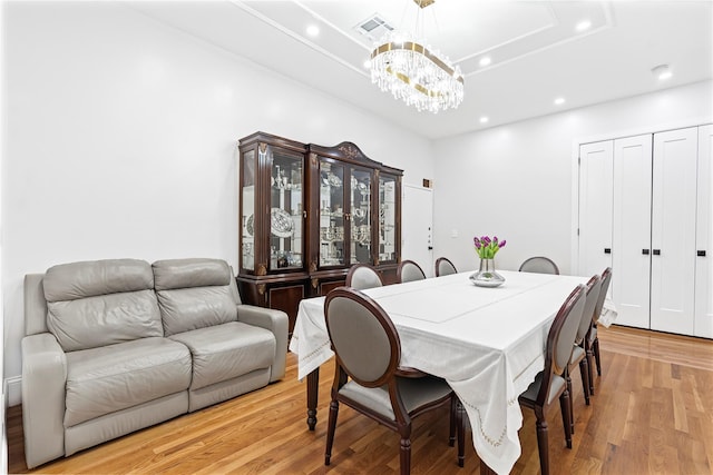 dining space featuring a chandelier and light hardwood / wood-style flooring