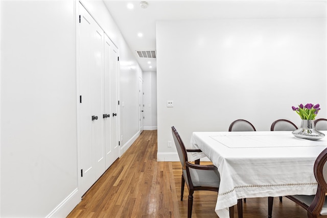 dining space with hardwood / wood-style flooring