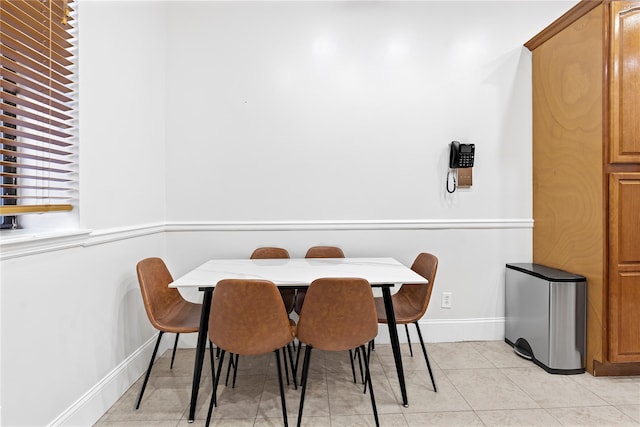 dining space featuring light tile patterned floors