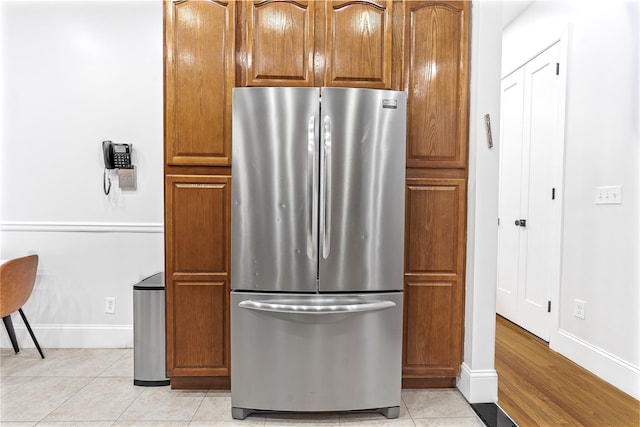 kitchen featuring light tile patterned floors and stainless steel refrigerator