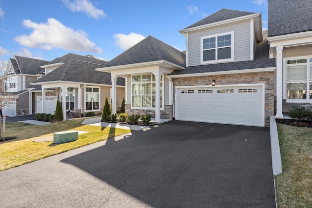 view of front of home featuring a garage and a front lawn