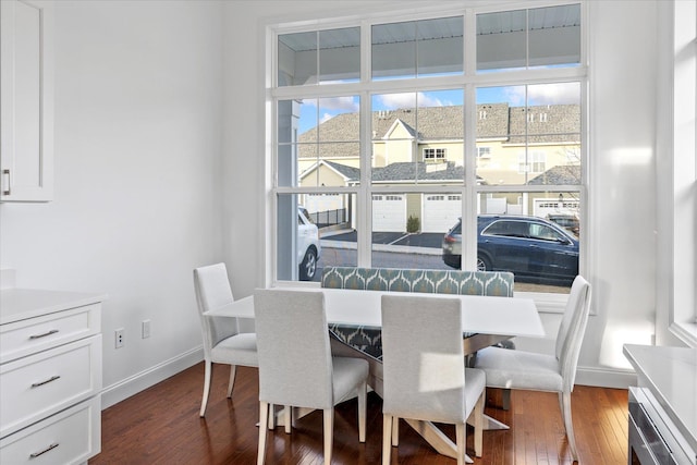 dining area with dark hardwood / wood-style flooring