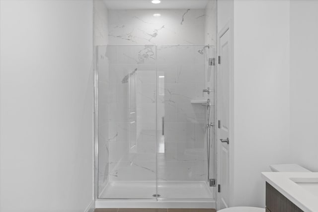 bathroom with vanity, toilet, and an enclosed shower