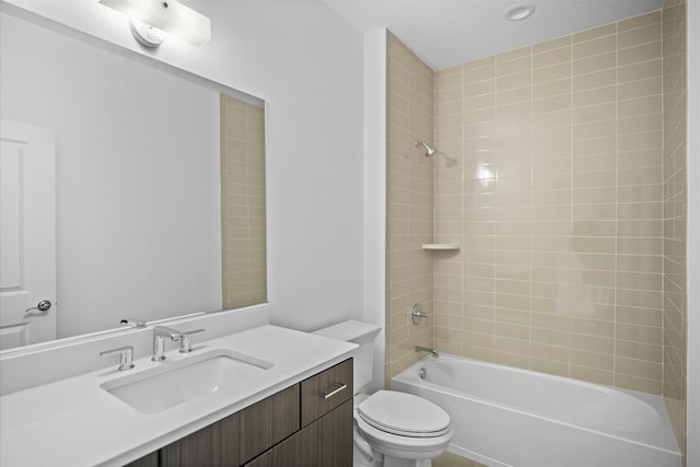 full bathroom with toilet, vanity, and tiled shower / bath