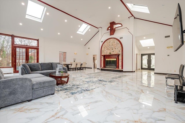 living room with a healthy amount of sunlight, high vaulted ceiling, and french doors