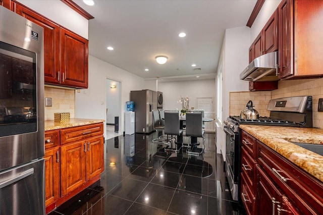 kitchen featuring decorative backsplash, appliances with stainless steel finishes, and light stone counters