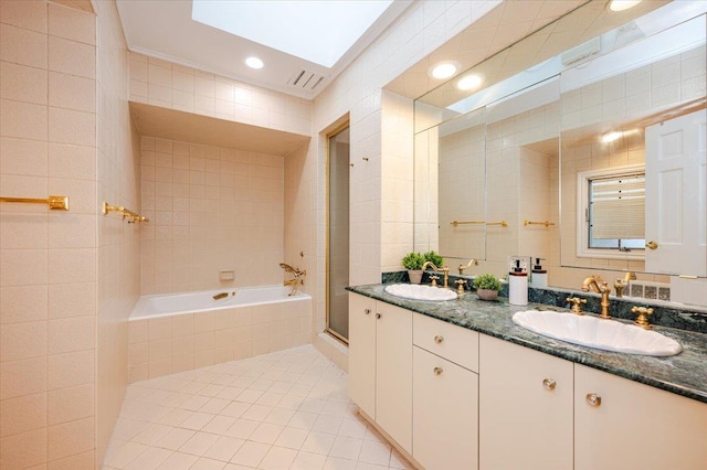 bathroom with a skylight, tile patterned flooring, vanity, independent shower and bath, and tile walls