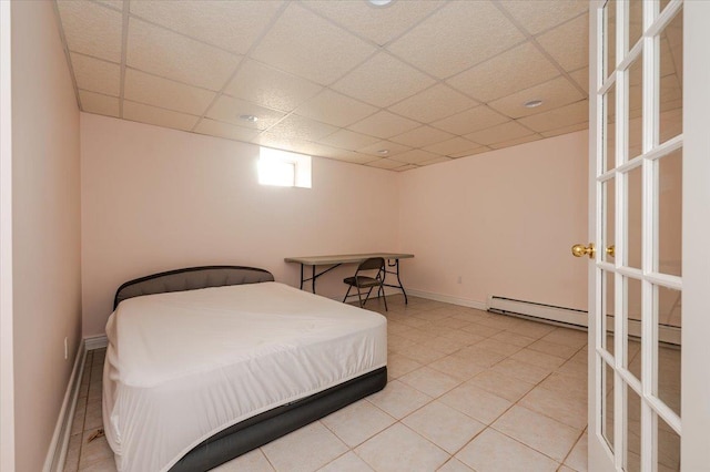 tiled bedroom featuring a drop ceiling