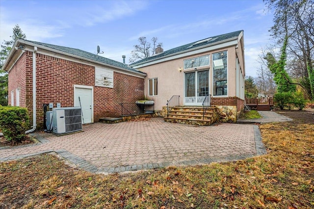 back of house with a patio and central AC unit