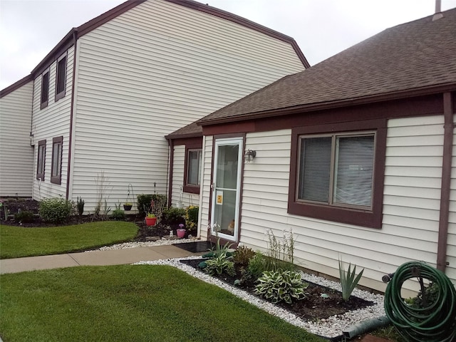 view of side of home with a lawn