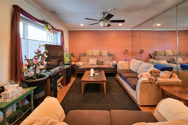 living room with ceiling fan, wood-type flooring, and crown molding