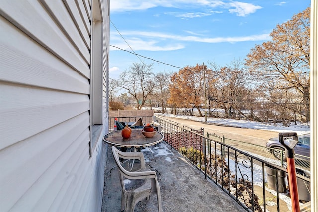 view of snow covered back of property