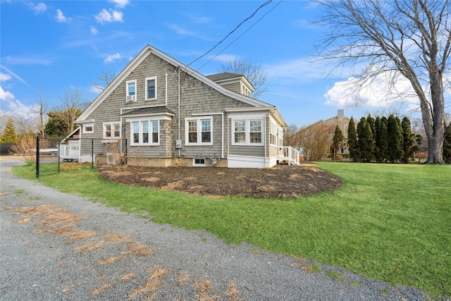 rear view of house featuring a lawn