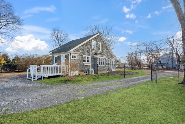 view of front of house with a deck and a front yard