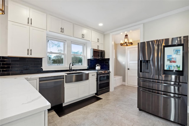 kitchen with appliances with stainless steel finishes, sink, white cabinets, backsplash, and light stone counters