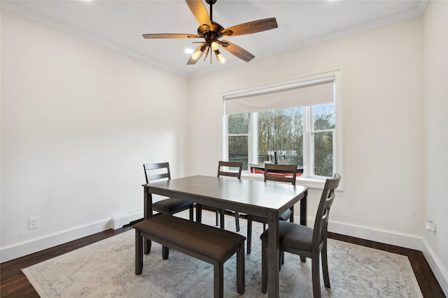 dining room featuring ceiling fan, dark hardwood / wood-style floors, and crown molding