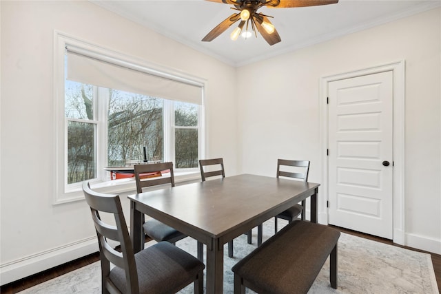 dining room featuring ceiling fan, crown molding, baseboard heating, and dark hardwood / wood-style flooring