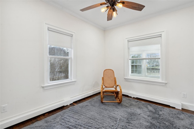 sitting room featuring ceiling fan, a baseboard heating unit, dark hardwood / wood-style floors, and crown molding