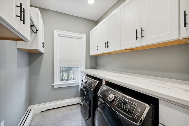 laundry room featuring cabinets and washing machine and clothes dryer